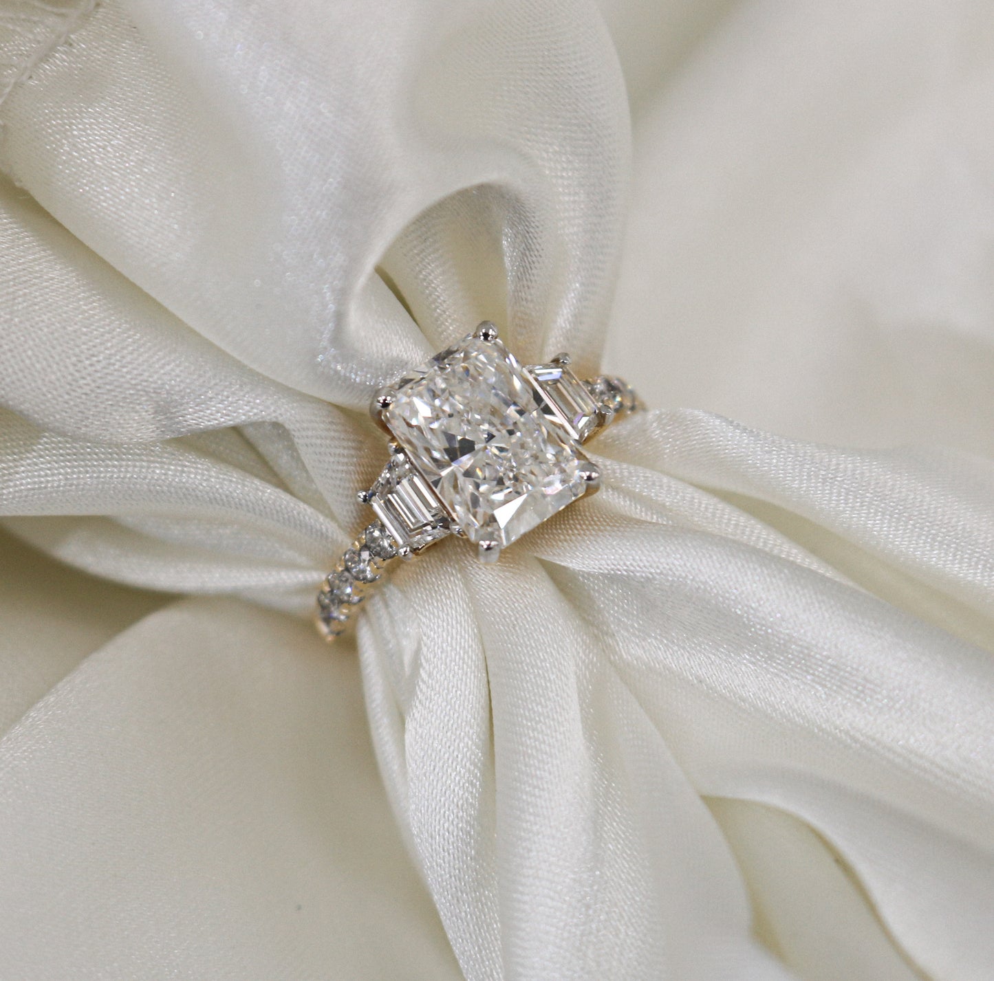 3.02 carat Radiant Lab Grown Diamond Center: 3-Stone in 18k Yellow Gold (VS1/E)